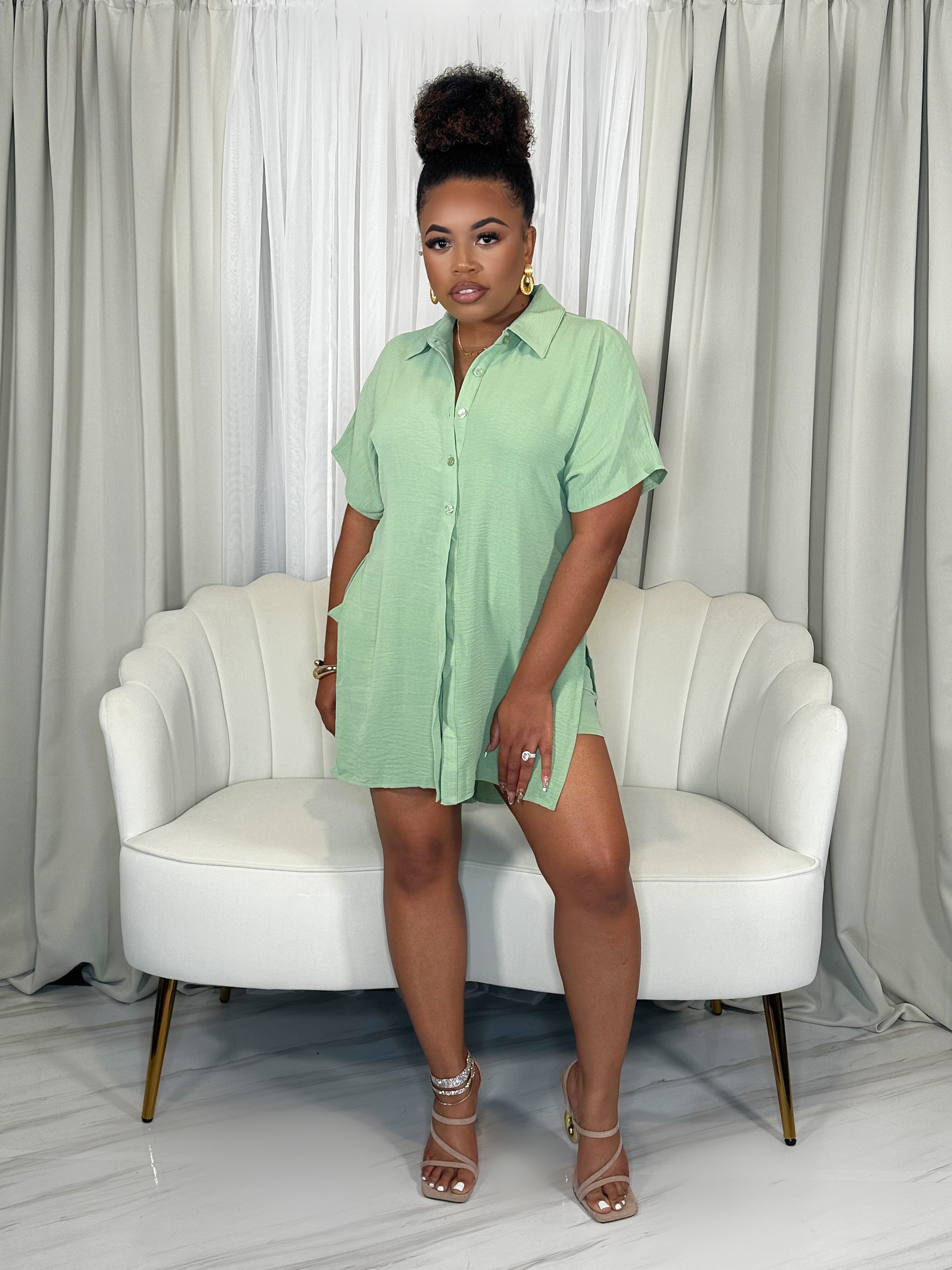 Black woman wearing light green two-piece short set – button-up top and high-waisted shorts